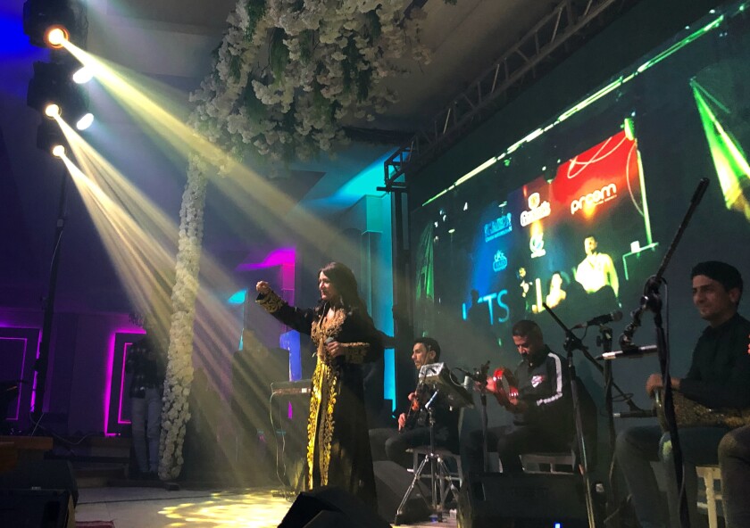 Iraqi singer Sajda Obeid gives a concert at the "Yarmouk Club" in Baghdad, Iraq, Monday, Dec. 13, 2021. Obeid is a unifying figure in Iraq's fractured society. For older Iraqis, the 63-year old is a symbol of a bygone golden era. To the young, her upbeat love songs and subtly racy lyrics have become a channel for self-expression in a largely conservative society. (AP Photo/Samya Kullab)