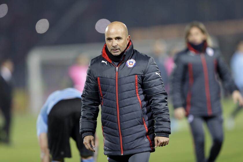 Chile's coach Jorge Sampaoli leaves the pitch after a Copa America quarterfinal soccer match against Uruguay at the National Stadium in Santiago, Chile, Wednesday, June 24, 2015. Chile won 1-0. (AP Photo/Jorge Saenz)