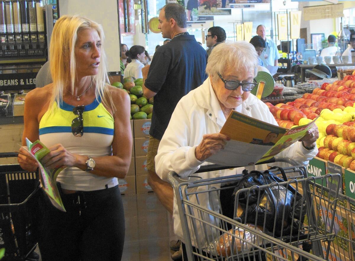 Customers shop at the Whole Foods Market at Fashion Island in Newport Beach. The grocery chain plans to open a new store in Irvine on March 16.