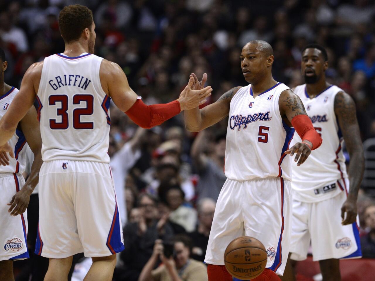 Clippes power forward Blake Griffin congratulates forward Caron Butler after he scored against the 76ers in a 101-72 victory on Wednesday night at Staples Center.