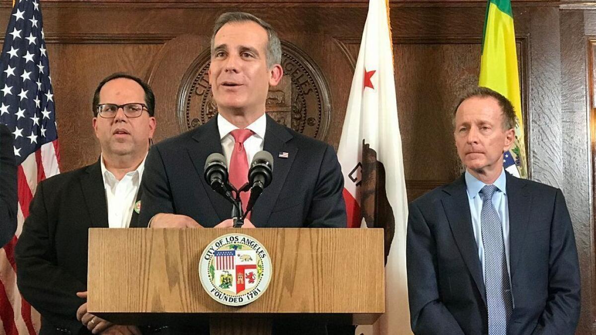 L.A. Mayor Eric Garcetti, center, speaks Tuesday after a contract agreement was reached between the L.A. teachers union and the school district. Behind him are union President Alex Caputo-Pearl, left, and L.A. Unified Supt. Austin Beutner.
