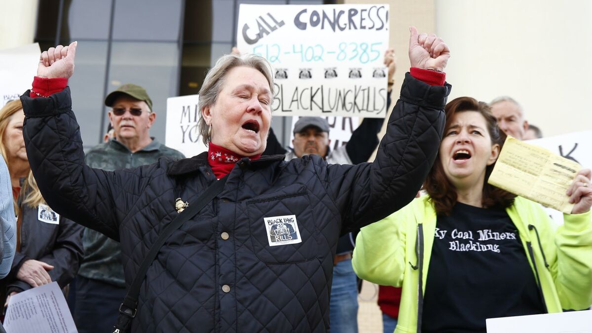 Patty Amburgey, of Letcher, Ky., left and Linda Adams, of Pikeville, Ky., both members of the Black Lung Association of Southeastern Kentucky, shout slogans during a protest near the office of Senate Majority Leader Mitch McConnell.