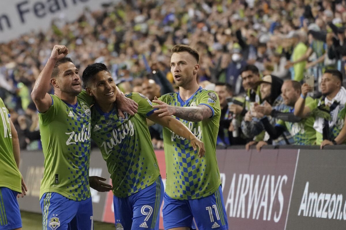 United States' Seattle Sounders forward Raul Ruidiaz (9) celebrates his goal with teammates during the second half of the second leg of the CONCACAF Champions League soccer final against Mexico's Pumas, Wednesday, May 4, 2022, in Seattle. (AP Photo/Ted S. Warren)
