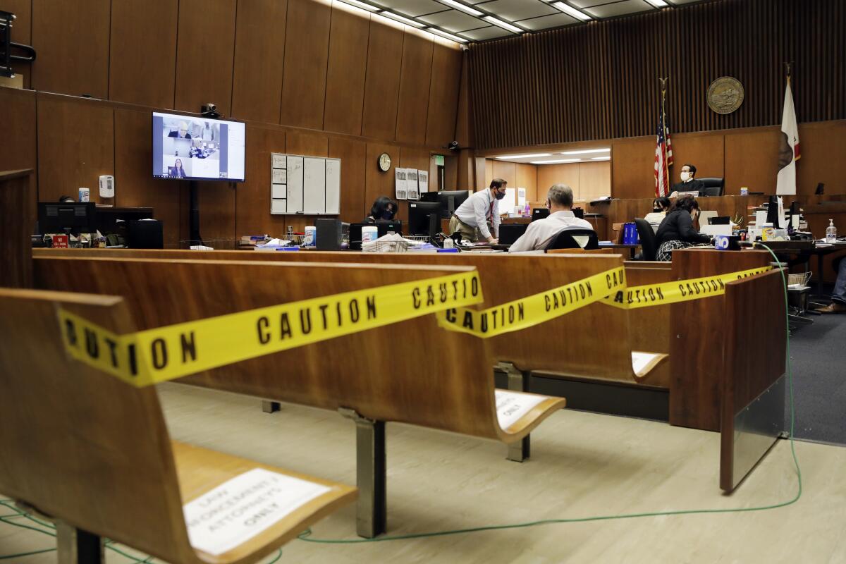 Los Angeles Superior Court Judge Miguel Espinoza holds video arraignments in his nearly empty courtroom.