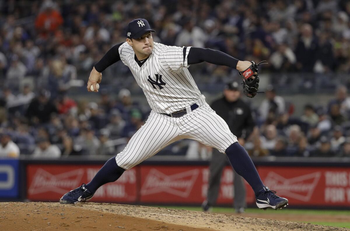 Reliever Tommy Kahnle pitches as a New York Yankee against the Houston Astros in Game 3 of 2019 ALCS.