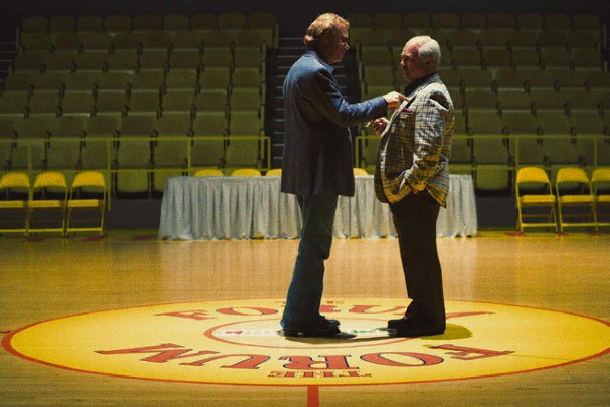 Two older men on a basketball court.