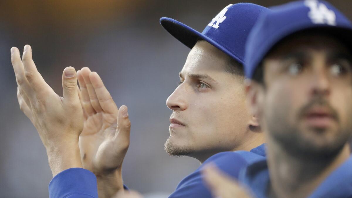 Dodgers shortstop Corey Seager applauds his team from the dugout during the game against the San Francisco Giants on June 19 at Dodger Stadium.