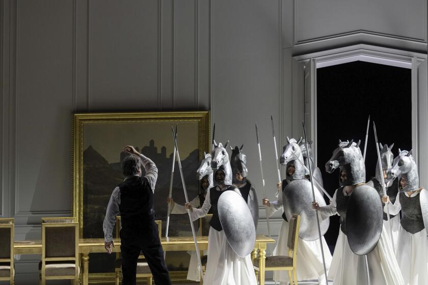 This image release by the Zurich Opera shows Tomas Konieczny, left, as Wotan with Valkyries in a rehearsal of Andreas Homoki’s production of Wagner’s “Die Walküre” at the Zurich Opera. (Monika Rittershaus/Zurich Opera via AP)