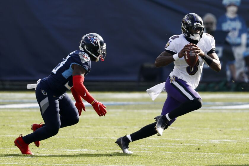 Baltimore Ravens quarterback Lamar Jackson (8) scrambles away from Tennessee Titans cornerback Desmond King, left, in the first half of an NFL wild-card playoff football game Sunday, Jan. 10, 2021, in Nashville, Tenn. (AP Photo/Wade Payne)