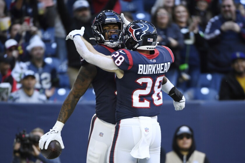 Houston Texans tight end Brevin Jordan (9) celebrates his touchdown catch with teammate Rex Burkhead (28) during the first half of an NFL football game, Sunday, Dec. 12, 2021, in Houston. (AP Photo/Justin Rex )