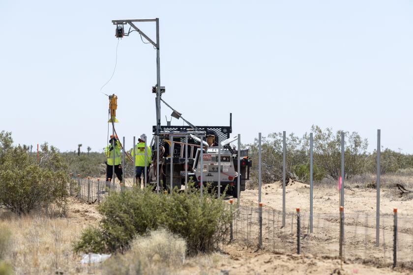 KERN COUNTY, CA - MAY 30: Fence posts are installed at an Aratina solar project site in Boron, CA on Thursday, May 30, 2024. Boron residents are concerned about the dust and the risk of contracting Valley fever. (Myung J. Chun / Los Angeles Times)