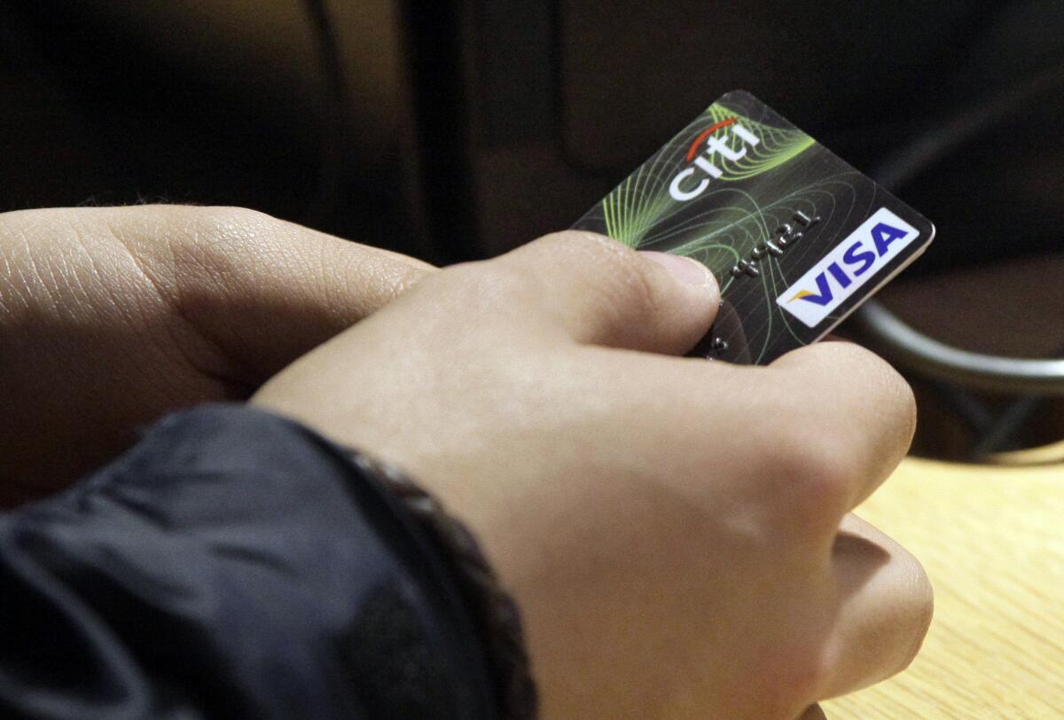A Visa credit card is tendered at opening of the Superdry store in New York's Times Square in 2012. The Supreme Court refused to hear a challenge by merchants to force regulators to lower so-called swipe fees.
