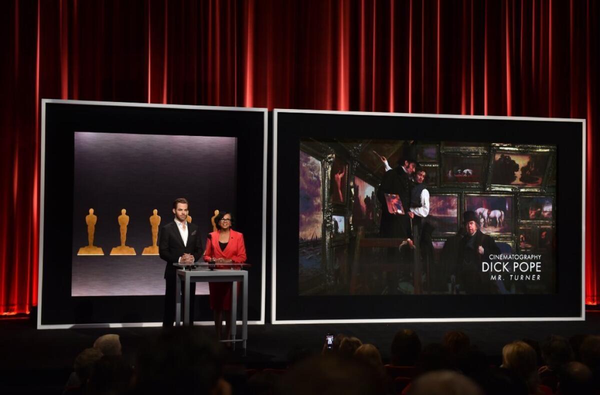 Chris Pine and Academy President Cheryl Boone Isaacs announce Dick Pope as a nominee for best cinematography in the film 'Mr. Turner' during the presentation of the Academy Awards nominations on Jan. 15.