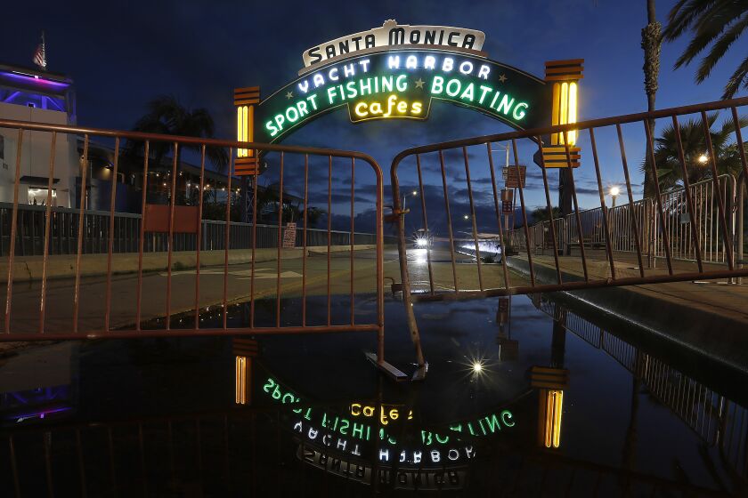 SANTA MONICA, CALIF. -MAR. 19, 2020. The lights are on but the Santa Monica Pier is closed to the public on Thursday, Mar. 19, 2020. Gov. Gavin Newson has ordred California residents to stay home as a precaution against the spread of coronavirus. (Luis Sinco/Los Angeles Times)