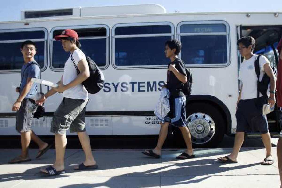 Jason Fujikuni, 17, Jonathan Lim, 16, Mako Inouye, 17, and Rikio Enouye, 17, get off the transit bus from Santa Monica in La Canada.