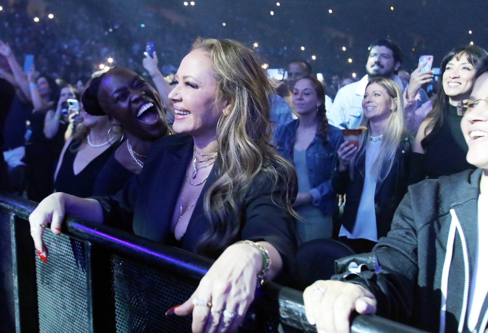 Actress Leah Remini is all smiles as she watches Marc Anthony.