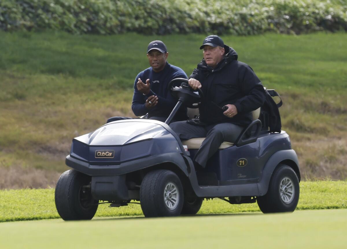 Tiger Woods is driven off the course after withdrawing during the second round of the Genesis Invitational.