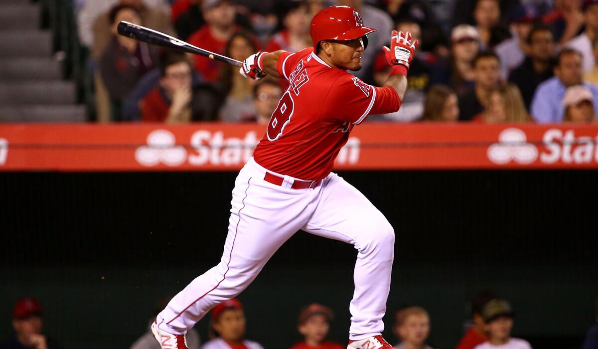 Angels' Carlos Perez hits an RBI single to center in the fourth inning during the Angels' 5-2 win over the Colorado Rockies at Angel Stadium on Tuesday.