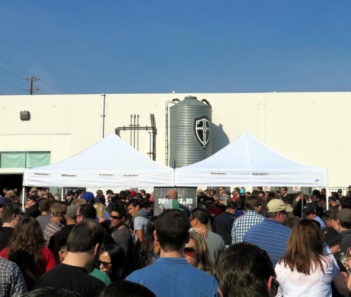 A crowd gathers in Noble Ale Works' parking lot to celebrate the brewery's third anniversary.