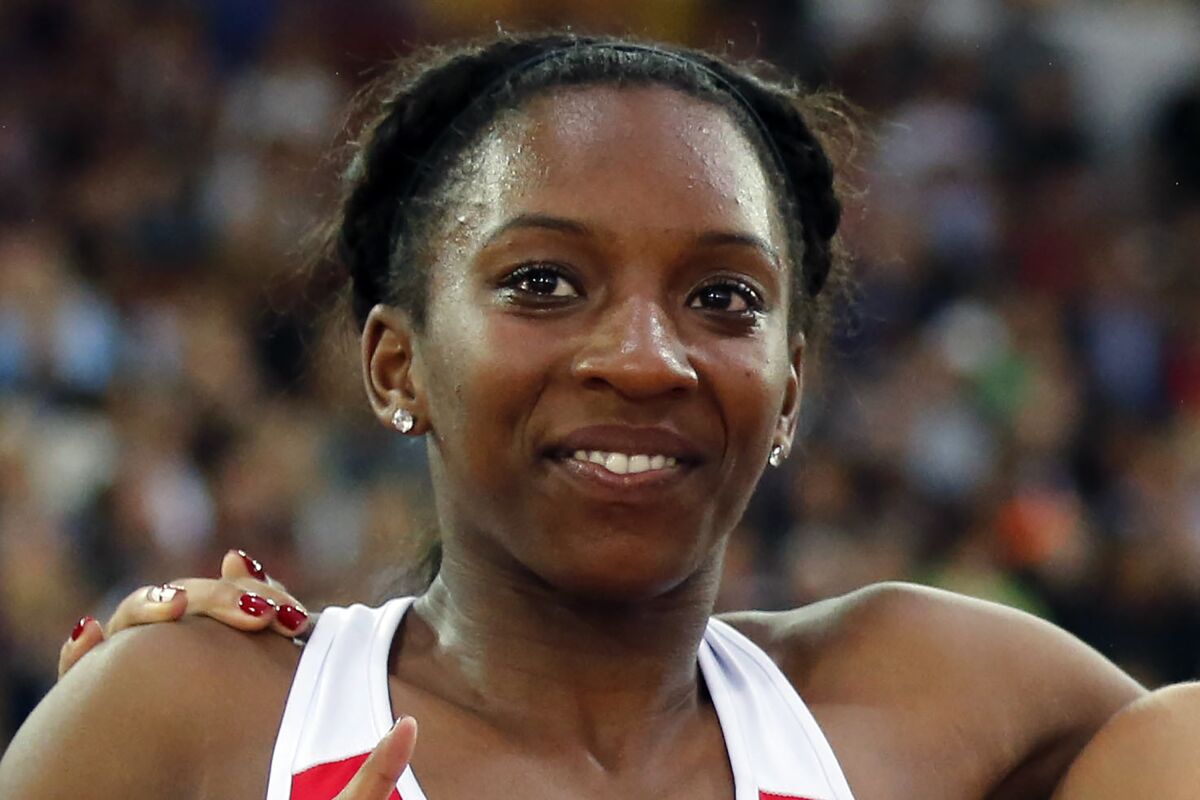 FILE - This July 31, 2014, file photo shows British sprinter Bianca Williams celebrating after the women's 200m final race at Hampden Park Stadium during the Commonwealth Games 2014 in Glasgow, Scotland. London police apologized to British sprinter Bianca Williams on Wednesday, July 8, 2020, after officers stopped and searched her car over the weekend. Metropolitan Police Commissioner Cressida Dick told the British parliament that police had apologized for “the distress it has clearly caused her.” (AP Photo/Frank Augstein, File)