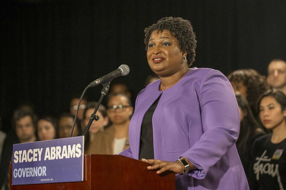 FILE - Georgia gubernatorial candidate Stacey Abrams makes remarks during a press conference at the Abrams Headquarters in Atlanta, on Nov. 16, 2018. When she ended her first bid to become Georgia governor in 2018, Abrams announced plans to sue over the way the state’s elections were managed. More than three years later, as she makes another run at the governor’s mansion, the lawsuit filed in Nov. 2018 by Abrams' Fair Fight Action organization is finally going to trial on Monday, April 11, 2022. (Alyssa Pointer/Atlanta Journal-Constitution via AP, File)