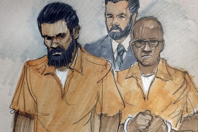 In this courtroom sketch, Jonas Edmonds, left, and Hasan Edmonds, right, stand in front of an FBI agent at a hearing in federal court in Chicago.