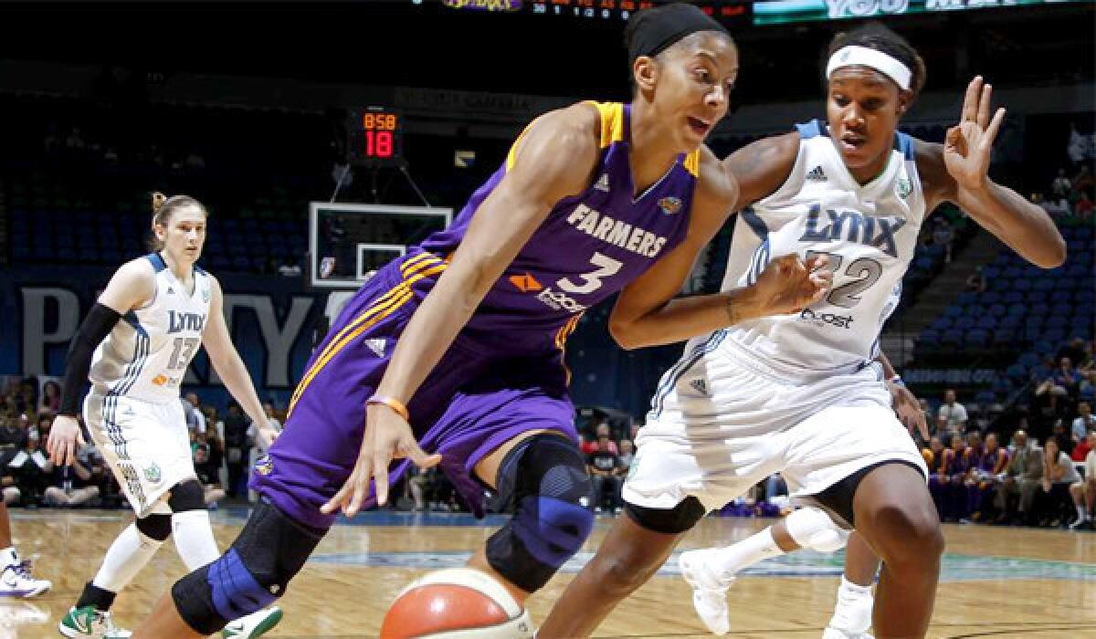 Candice Parker drives against Maya Moore during a meeting of the Sparks and Minnesota Lynx last season.
