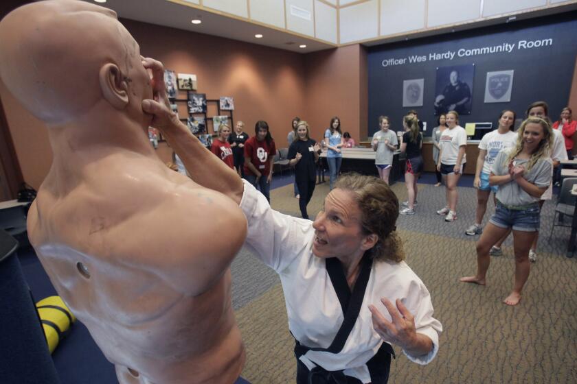 In this photo made Saturday, March 26, 2011, Marilyn Kirby gives a self defense class to debutantes in Plano, Texas. The debutantes are in a program benefiting the Plano Symphony Orchestra which has included instruction on everything from exhibiting grace and poise to how to jab fingers into the eyes of an attacker. (AP Photo/LM Otero)