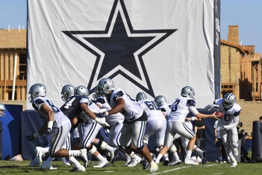FILE - In this Monday, July 29, 2019, file photo, Dallas Cowboys practice at the NFL football team's training camp in Oxnard, Calif. The NFL has informed teams their training camps will open on time. League executive Troy Vincent sent a memo to general managers and head coaches on Saturday, July 18, 2020 informing them rookies are to report by Tuesday, quarterbacks and injured players by Thursday and all other players should arrive by July 28. (AP Photo/Michael Owen Baker, File)