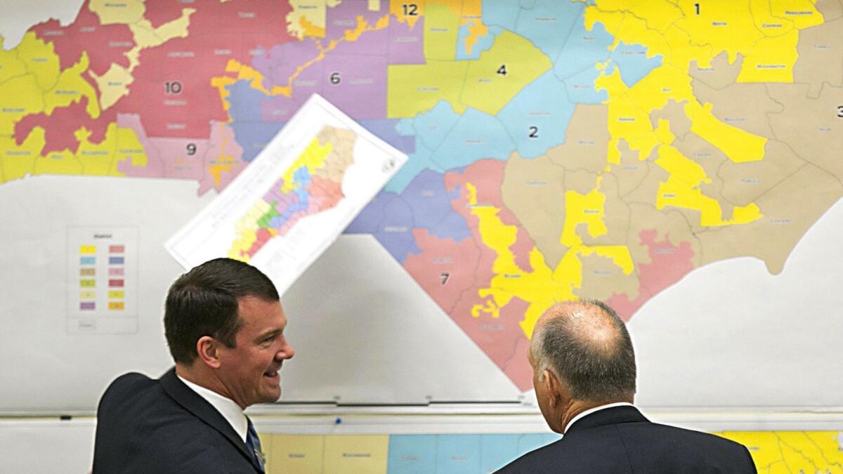 In February 2016, Republican state Sens. Dan Soucek, left, and Brent Jackson review historical maps in an extra session of the North Carolina General Assembly.