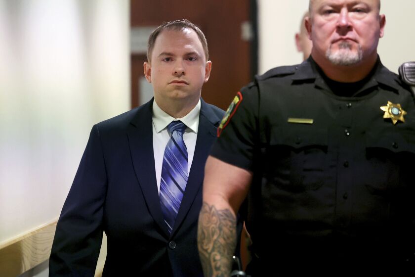Aaron Dean arrives to the 396th District Court in Fort Worth on Monday, Dec. 5, 2022, in Fort Worth, Texas, for the first day of his trial in the murder of Atatiana Jefferson. Dean, a former Fort Worth police officer, is accused of fatally shooting Jefferson in 2019. (Amanda McCoy/Star-Telegram via AP, Pool)