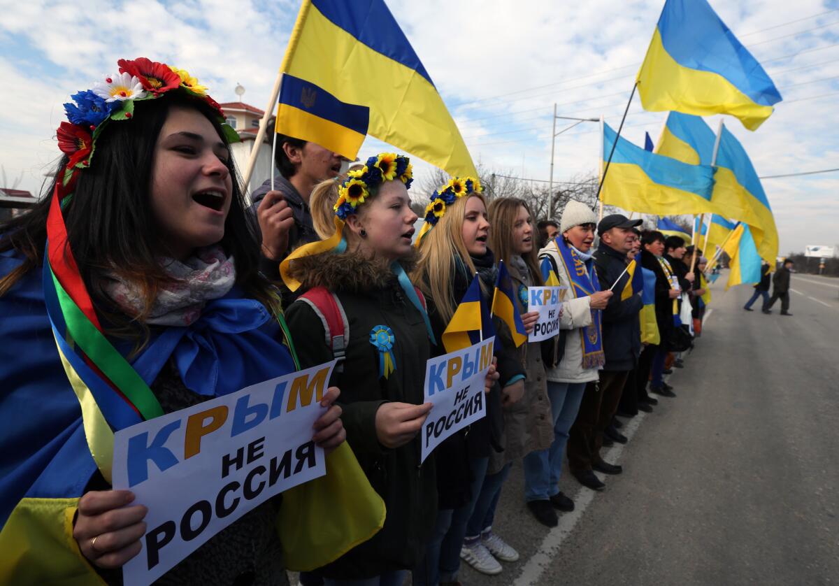 Demonstrators hold signs that read: "Crimea is not Russia" during a protest action in Simferopol, Ukraine, on Friday.