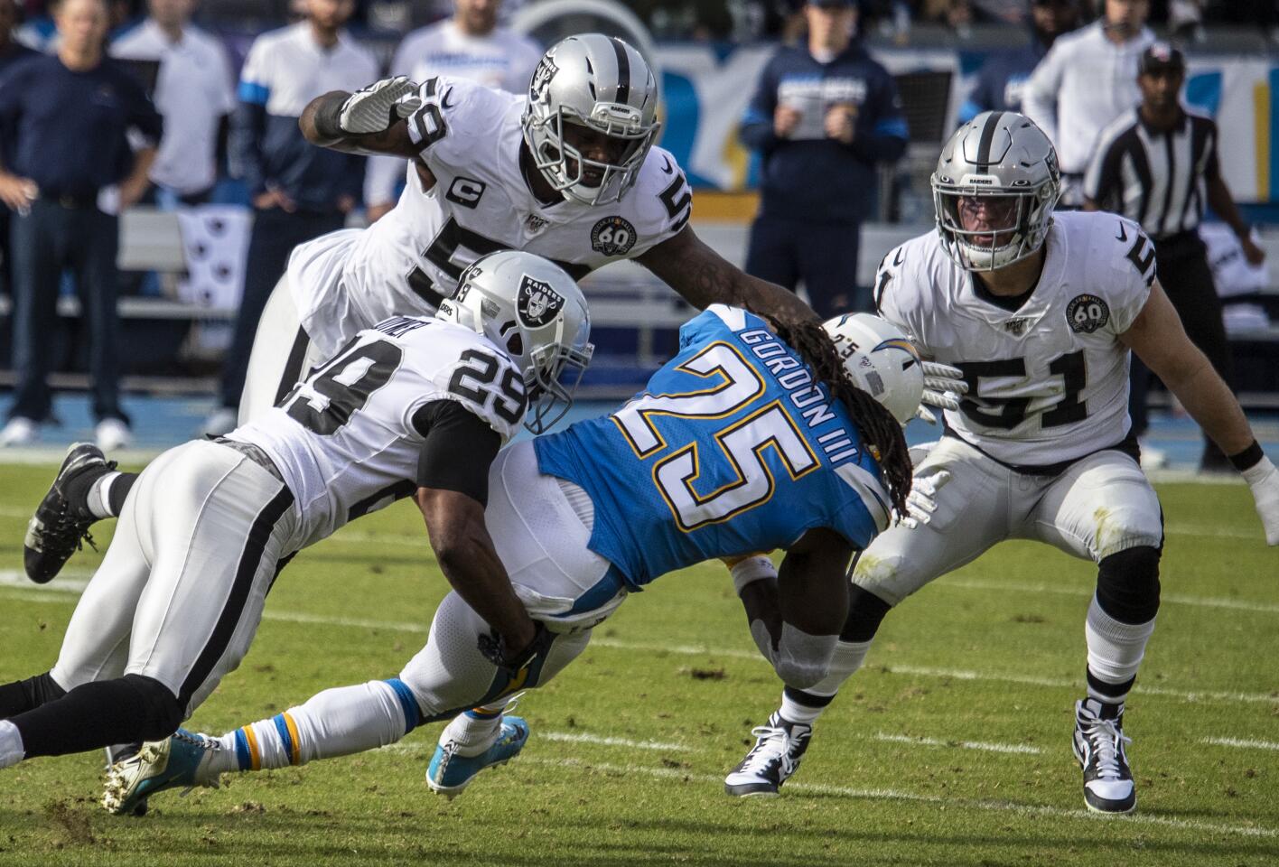 Chargers running back Melvin Gordon is brought down by Oakland Raiders free safety Lamarcus Joyner during the first quarter.