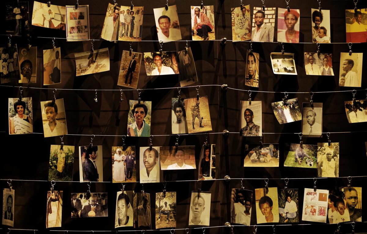 In this Friday, April 5, 2019 file photo, family photographs of some of those who died hang on display in an exhibition at the Kigali Genocide Memorial centre in the capital Kigali, Rwanda.
