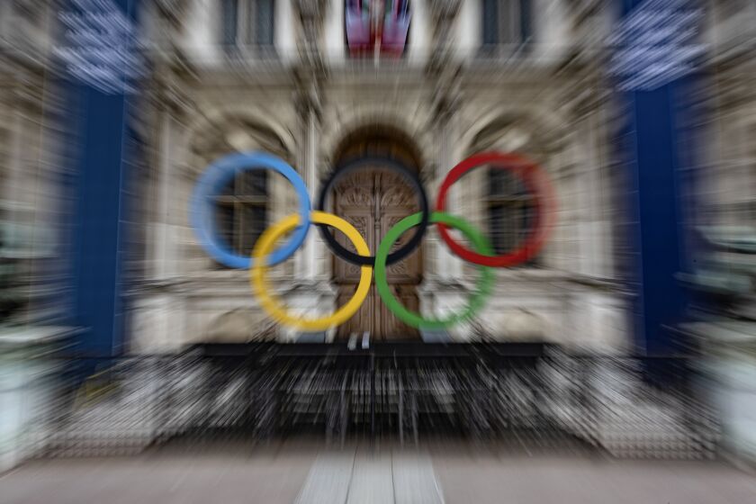 FiILE - The Olympic rings are seen in front of the Paris City Hall, in Paris, Sunday, April 30, 2023. French security experts have expressed misgivings about size and complexity of the security operation that will be needed to safeguard Paris' ambitions for the unprecedented opening gala along the River Seine (AP Photo/Aurelien Morissard, File)