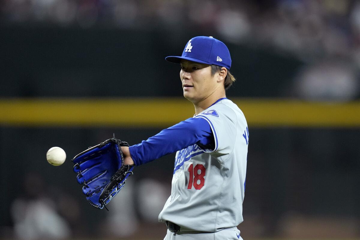 Yoshinobu Yamamoto gets a new baseball during the fourth inning.