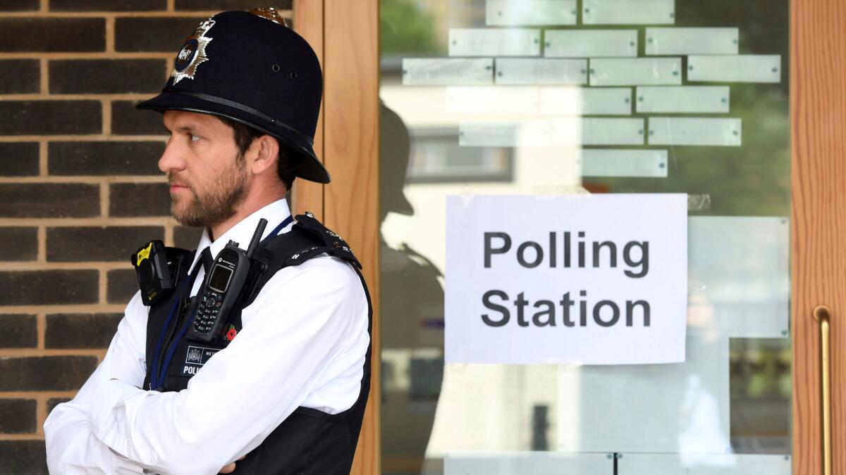 A police officer is stationed Thursday outside a London polling station.