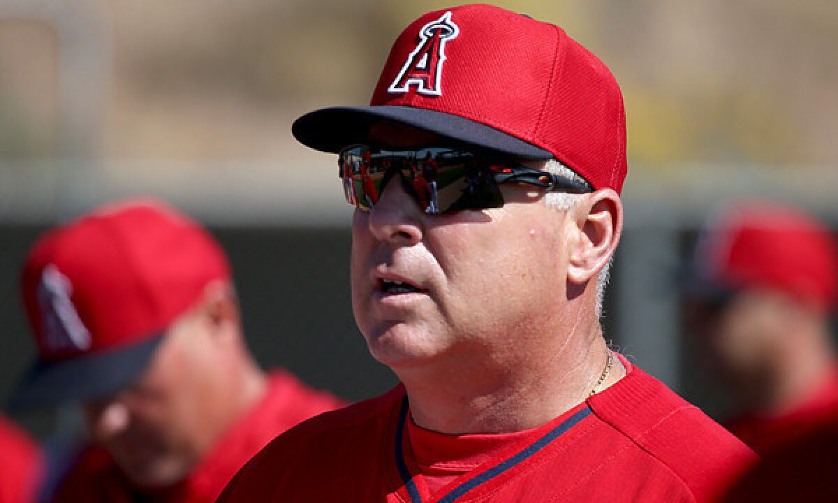 Angels Manager Mike Scioscia speaks with his players during a practice session Feb. 26. Scioscia and the Angels saw the Seattle Mariners successfully get a call overturned -- to the Angels' disadvantage -- via instant replay during their Cactus League game Tuesday.