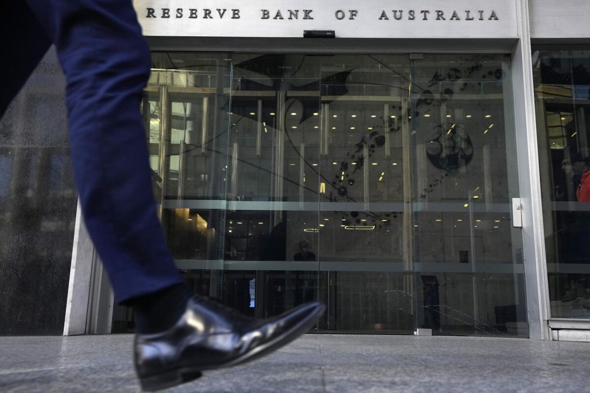 A man walks past the Reserve Bank of Australia in Sydney on Tuesday, Aug. 2, 2022. Australia’s central bank on Tuesday boosted its benchmark interest rate for a fourth consecutive month to a six-year high of 1.85%. (AP Photo/Rick Rycroft)