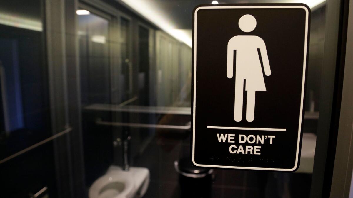 A sign indicating a gender-neutral bathroom is seen at the 21c Museum Hotel in Durham, N.C., on May 12, 2016.