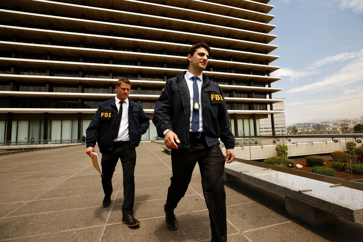 FBI agents leave the downtown L.A. headquarters of the DWP after serving a search warrant in July 2019.