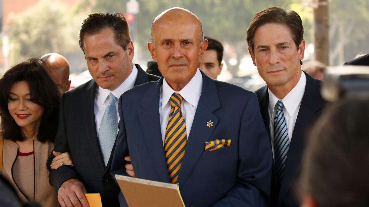 Former Los Angeles County Sheriff Lee Baca, his wife and attorneys depart courthouse after his May sentencing.