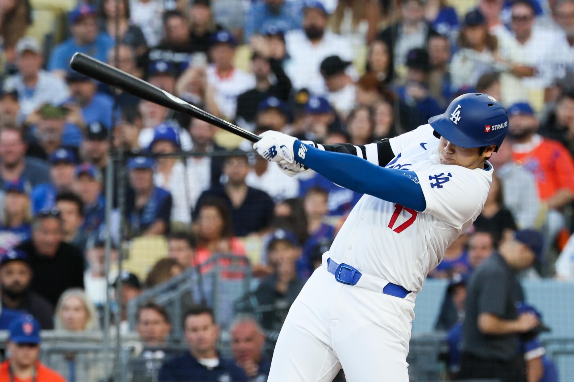 Dodgers star Shohei Ohtani hits a run-scoring single against the New York Mets in Game 1 of the NLCS on Oct. 13.