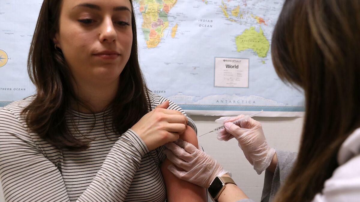 Simone Groper receives a flu shot at a Walgreens pharmacy in San Francisco. People are being encouraged to get flu shots even though the vaccine has been estimated to be only 30% effective in combating influenza.