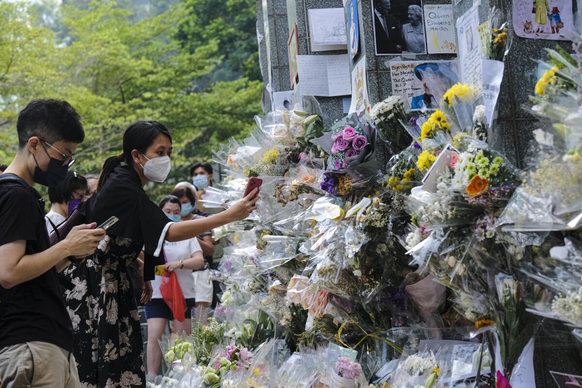 Flowers and tributes in memory of Queen Elizabeth II outside the British Consulate in Hong Kong.