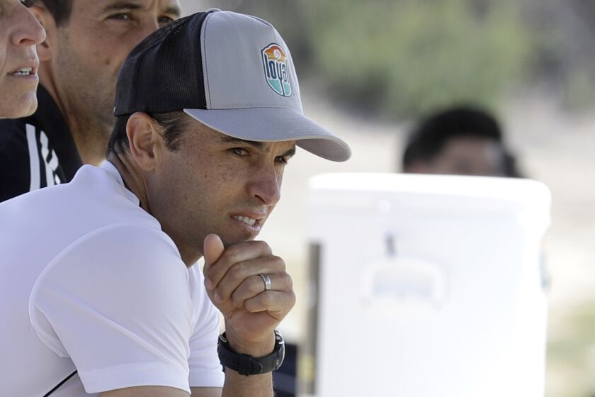 FILE - In this March 4, 2020, file photo, Landon Donovan, coach of the expansion San Diego Loyal of the professional second-division United Soccer League, watches from the bench during a scrimmage in Chula Vista, Calif. (AP Photo/Gregory Bull, File)
