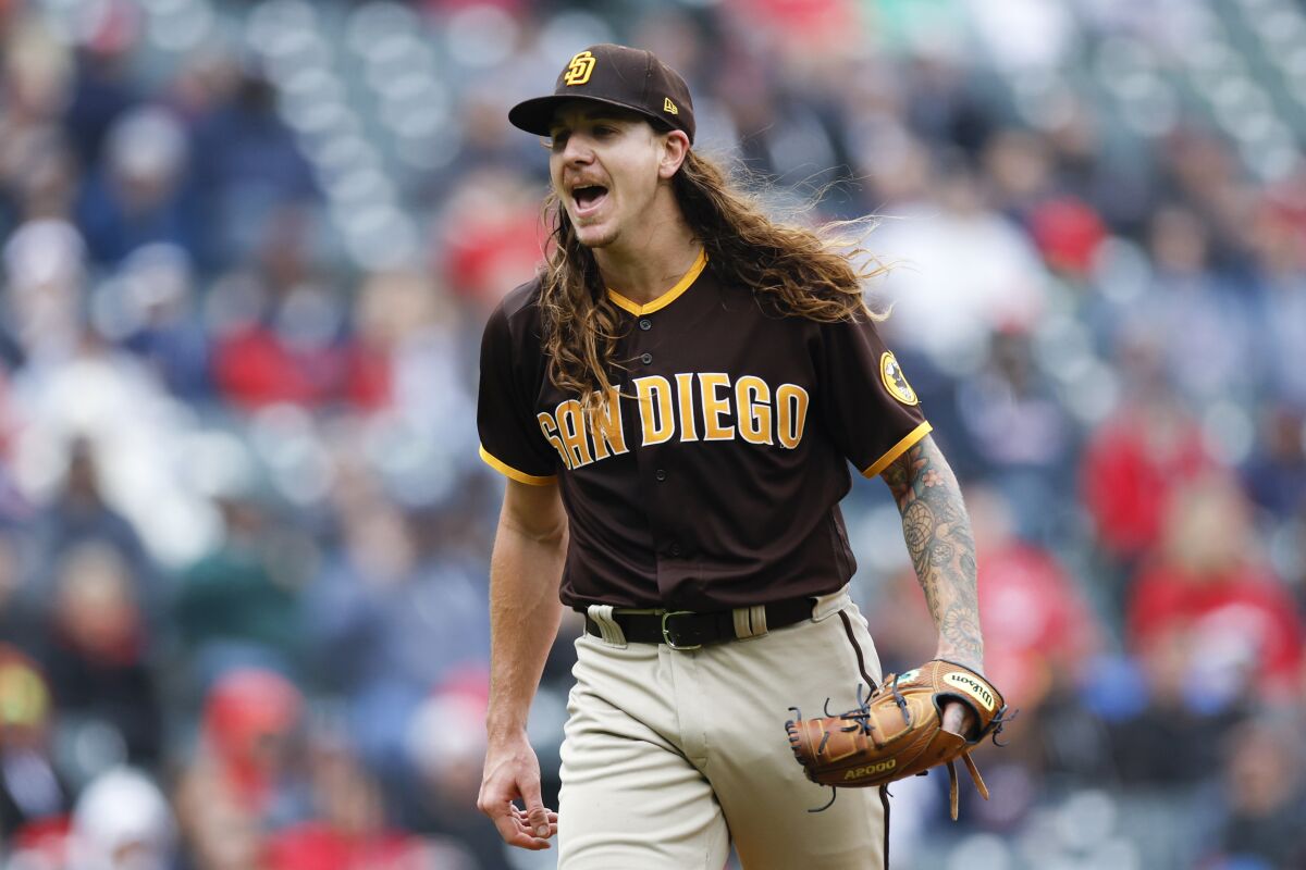San Diego Padres starting pitcher Mike Clevinger celebrates after striking out Cleveland Guardians' Owen Miller during the third inning in the first baseball game of a doubleheader, Wednesday, May 4, 2022, in Cleveland. (AP Photo/Ron Schwane)