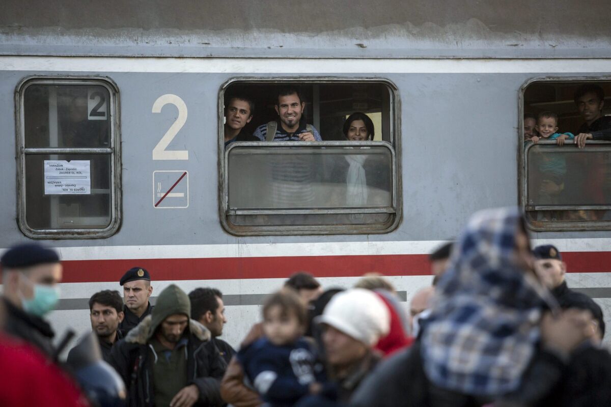 Migrants look out of windows of a train at the railway station in Cakovec, Croatia, near the border with Slovenia.