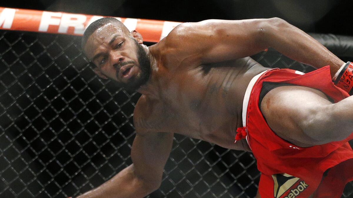 Jon Jones kicks Daniel Cormier during their light heavyweight title fight at UFC 182 in Las Vegas on Jan. 3, 2015.