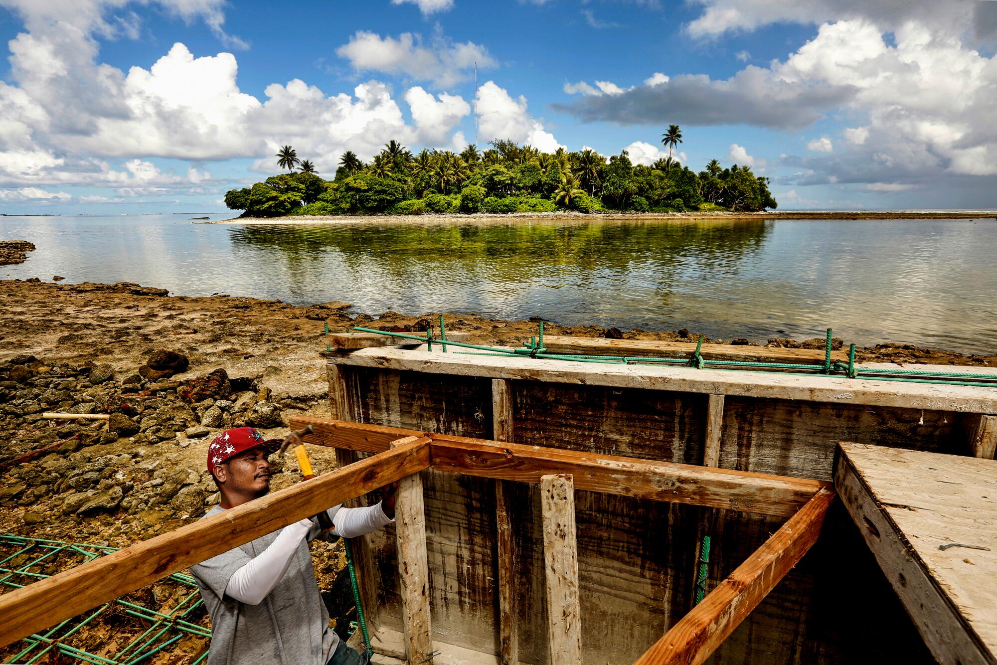  Job Atlaia works on building a sea wall on the northwest end of Majuro in the summer of 2018. 